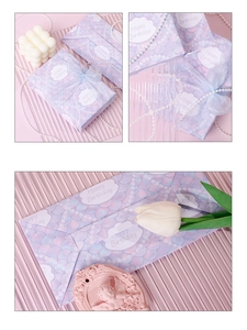 Detail of purple mermaid scale gift packaging with Happy Birthday print and pearl handle