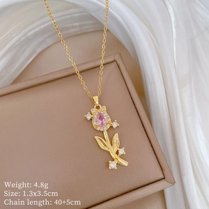 Detail of gold tulip pendant with pink crystal inlay and specifications displayed