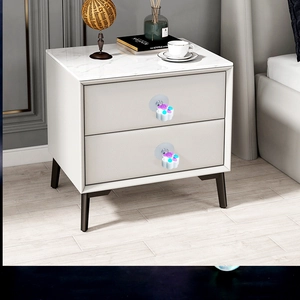 Cute cat paw drawer handle installed on a white marble nightstand drawer for home decor