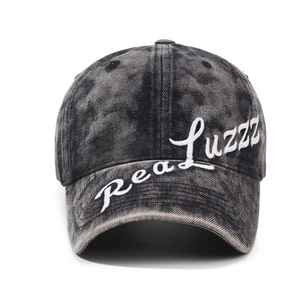 Vintage washed black baseball cap with white script embroidery and adjustable metal buckle