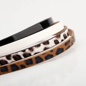 Four stylish thin waist belts for women in black, white, and classic leopard prints