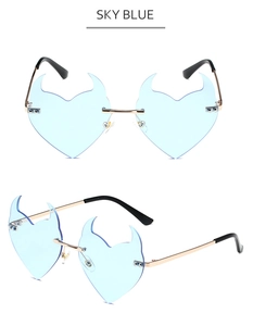 Detail of sky blue heart-shaped devil horn rimless sunglasses with gold metal temples