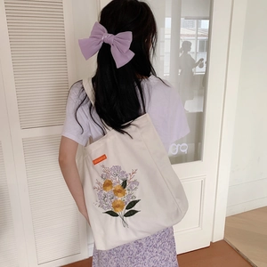 Minimalist canvas tote bag with floral embroidery and large capacity for daily use