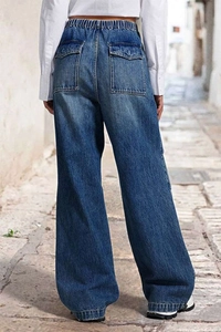 Outdoor street style back view of wide-leg denim jeans showing cargo pockets and elastic waist