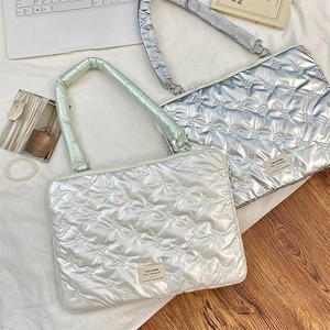 Quilted laptop sleeve featuring bow embroidery and soft protective padding design
