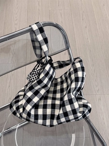 Minimalist black and white plaid canvas shoulder bag with matching ball pendant accessory