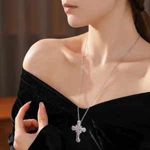 Elegant silver zircon cross pendant necklace with lilac gemstones on a female model