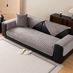 Detail of gray thickened flannel sofa cover with quilted plush texture for winter comfort