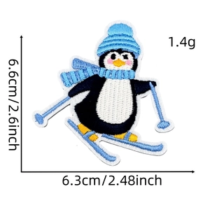 Detailed view of penguin skiing embroidery patch with 6.6cm x 6.3cm dimensions