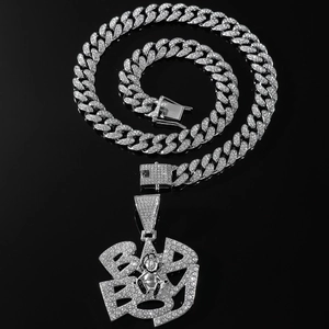 Silver Miami Cuban chain with iced-out rhinestone baby pendant on black background
