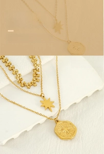 Detailed view of layered gold star coin necklaces with an eight-pointed star pendant
