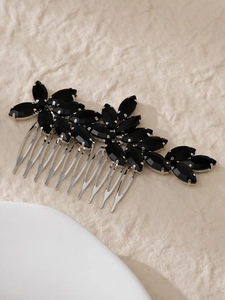 Macro detail of bridal hair comb with black marquise stones in a leaf pattern