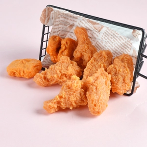 Realistic PVC fried chicken model with drumsticks and wings in a black metal basket