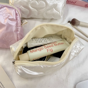 Quilted heart cosmetic bags in pink and white showing spacious interior with accessories