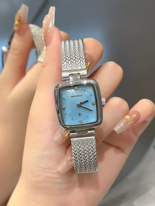 Detail of square blue mother-of-pearl dial with diamond markers and silver mesh strap