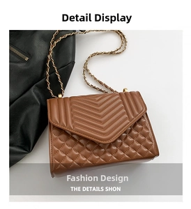 Detail of caramel brown quilted shoulder bag with gold chain strap and V-pattern stitching