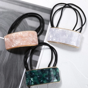 Three-piece acetate hair ring set with rectangular charms and golden borders for ponytails