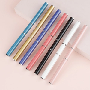 Close-up of dual-ended nail extension pens in seven metallic colors on a pink background