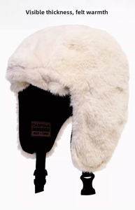 Detail of warm off-white plush trapper hat showing thick faux fur and inner brand label