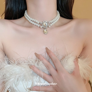 Double-layer pearl choker with rectangular crystal and teardrop pendant on model
