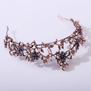 Macro detail of baroque bridal crown with black crystals, white pearls, and floral metalwork