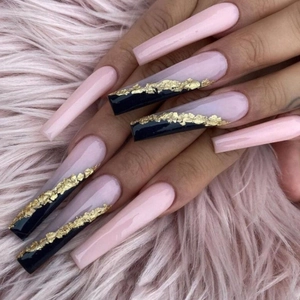 Macro detail of long coffin nails with pink and black colors and gold foil accents