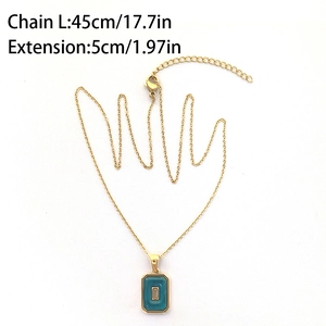 Detail showing 45cm gold chain and green enamel rectangle pendant with stone