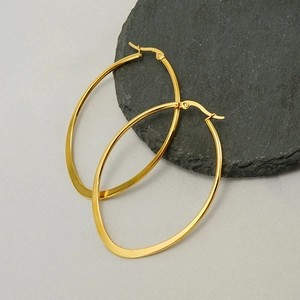 Polished 18k gold plated stainless steel oval hoop earrings on textured stone base