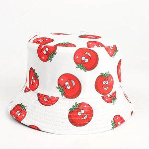 Close-up of a white bucket hat with cute cartoon tomato prints and smooth cotton texture