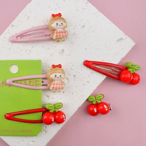 Pink and red cartoon fruit hair clips for girls featuring cherry and character designs