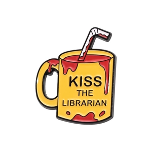 Yellow coffee mug enamel pin with Kiss The Librarian text and red liquid detail