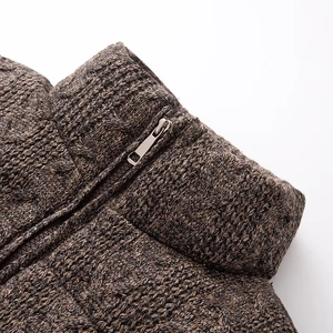 Macro detail of high-quality knit texture and silver metal zipper on winter cardigan