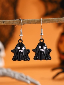 Detailed close-up of ghost earrings for Halloween with black and white enamel finish