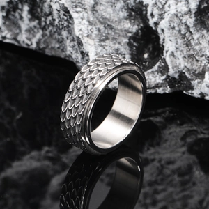 Vintage dragon scale titanium steel rotatable ring for men on black rock background