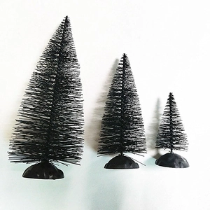 Three miniature black bottle brush Christmas trees in graduated sizes on black bases