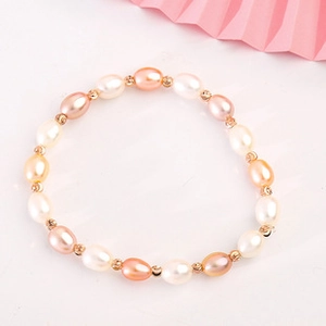 Detailed macro view of 14K gold plated bracelet with multi-colored baroque natural pearls
