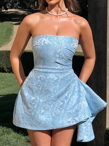Detail of light blue strapless dress with jacquard texture and side ruffled structure