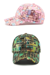 Detailed view of pink and black sequined baseball caps with sparkly plaid patterns