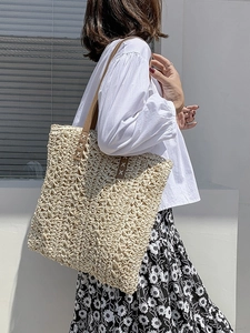 Artistic woven hollow tote bag with brown leather handles and ivory crochet texture