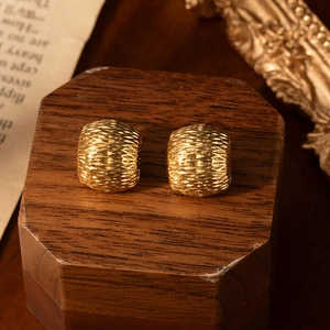Minimalist gold C-shaped stainless steel earrings with textured honeycomb pattern