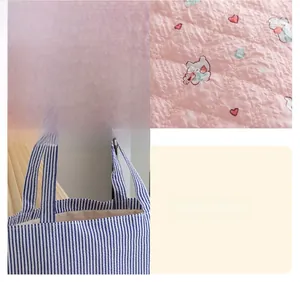 Close-up of quilted floral fabric texture and precise stitching on tote bag handles