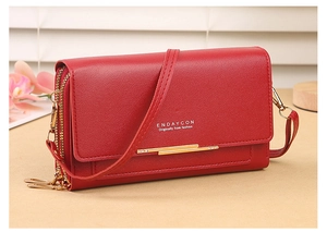 Detail of red PU leather bag with lychee texture and gold rhinestone trim