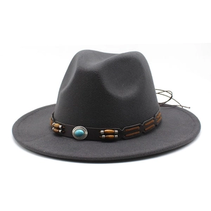 Detail of western fedora hat with turquoise stone and brown leather bead band