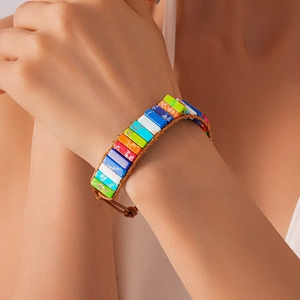 Detail of bohemian hand-woven leather bracelet featuring colorful natural stone beads