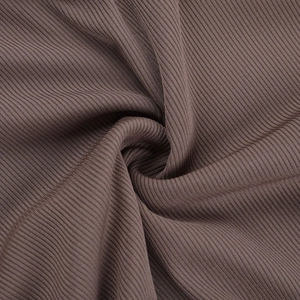 Macro shot of dark brown ribbed knit fabric texture and soft material pleats