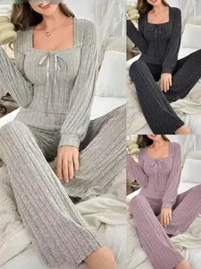 Detail of ribbed knit loungewear set with U-neck and bow tie in grey and purple colors