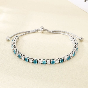 Detail of adjustable silver snake chain with blue and white round-cut tennis bracelet stones