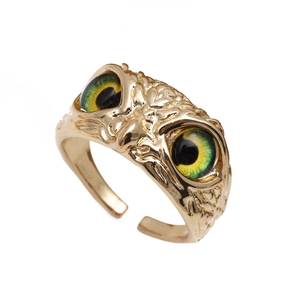 Vintage gold owl open ring featuring detailed relief and vibrant green resin eyes