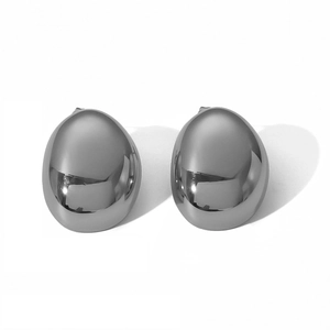 Macro shot of silver oval stainless steel stud earrings with a polished mirror finish