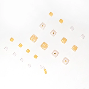 Yellow checkered press-on toenails with white flower smiley face designs for summer